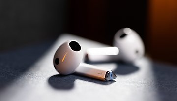 Two Samsung Galaxy Buds 3 wireless earbuds resting on a dark surface.