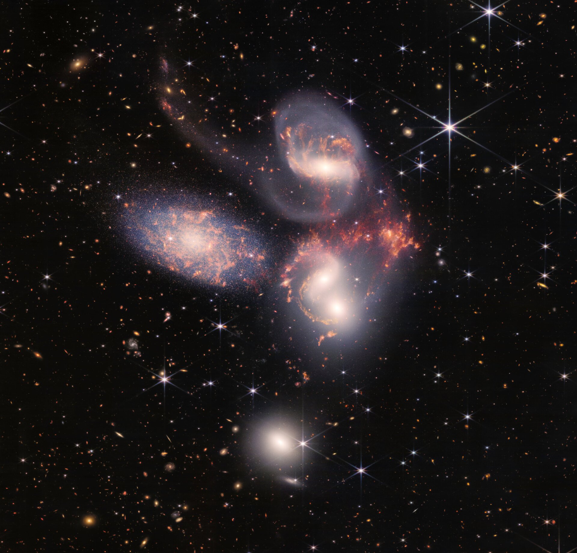 Stephan’s Quintet, a group of five galaxies seen by Webb in near- and mid-infrared light.