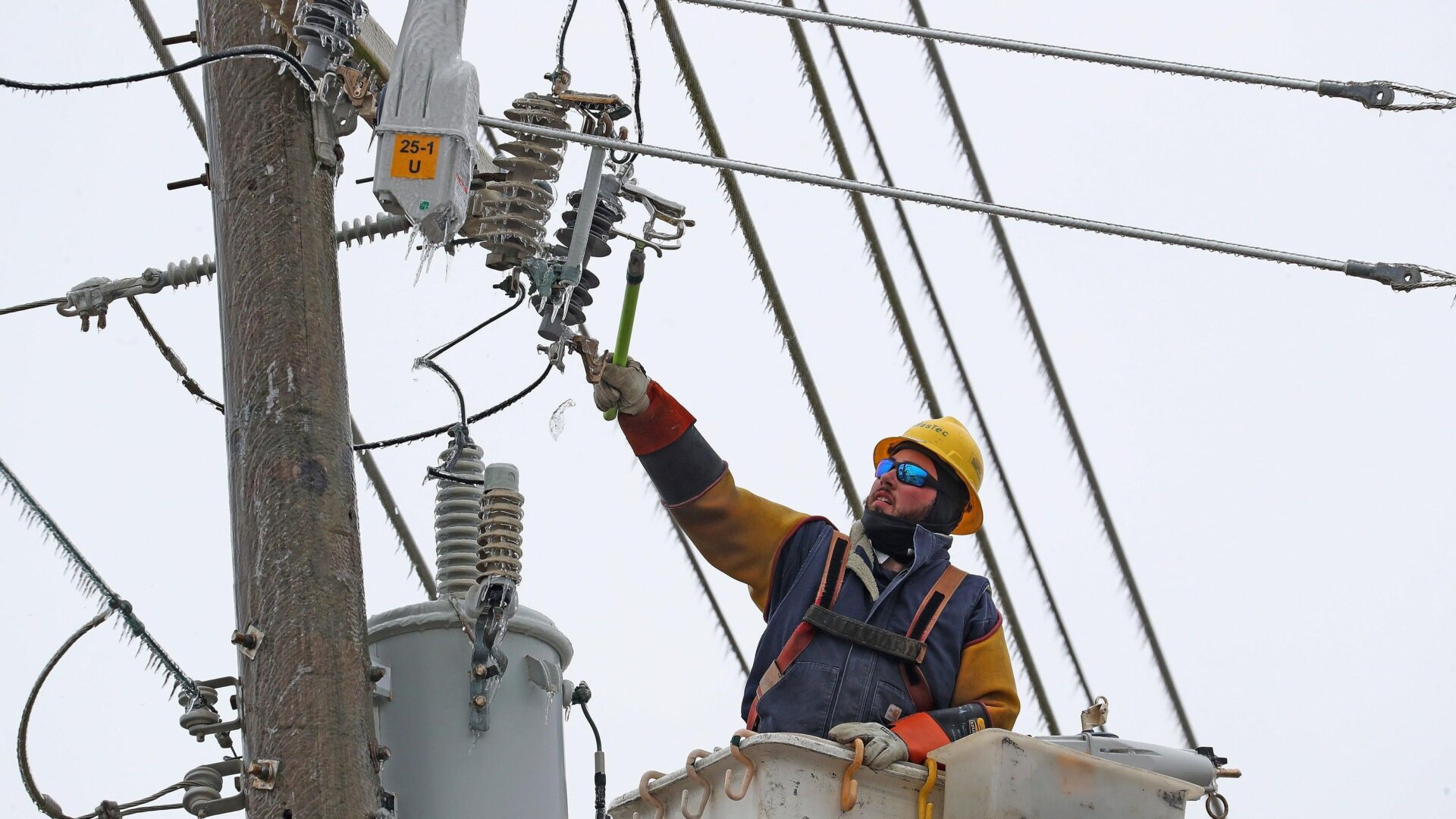 A Duke contractor repairs a power line during a storm in North Carolina in January 2022.