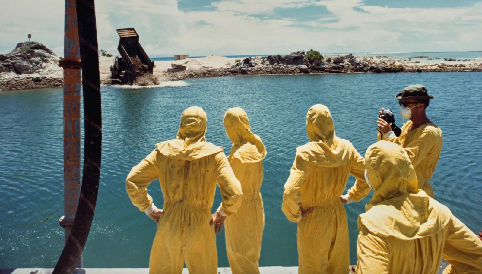 U.S. military officers watch nuclear waste being dumped on Runit Island in the Marshall Islands.