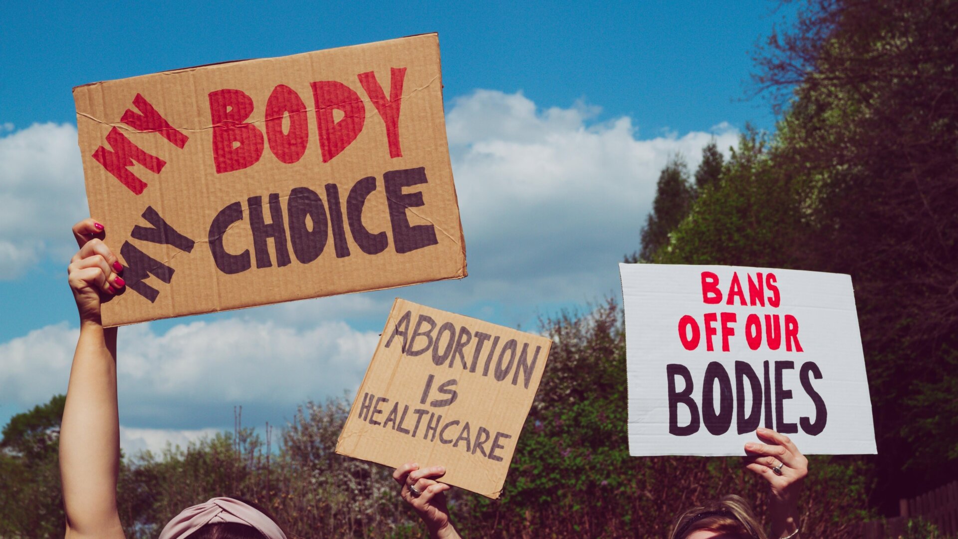 Protesters holding signs supporting abortion rights.