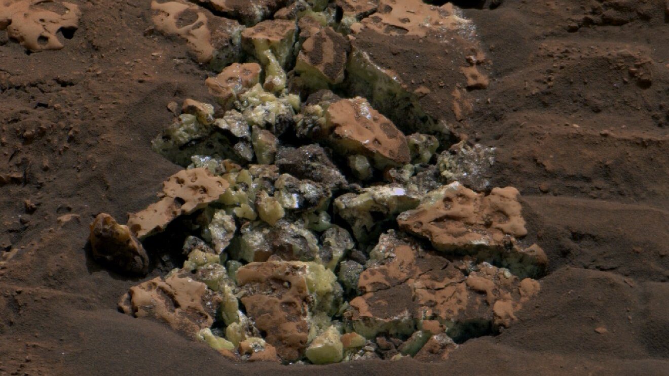 A cracked-open rock revealed yellow crystals of sulfur. 