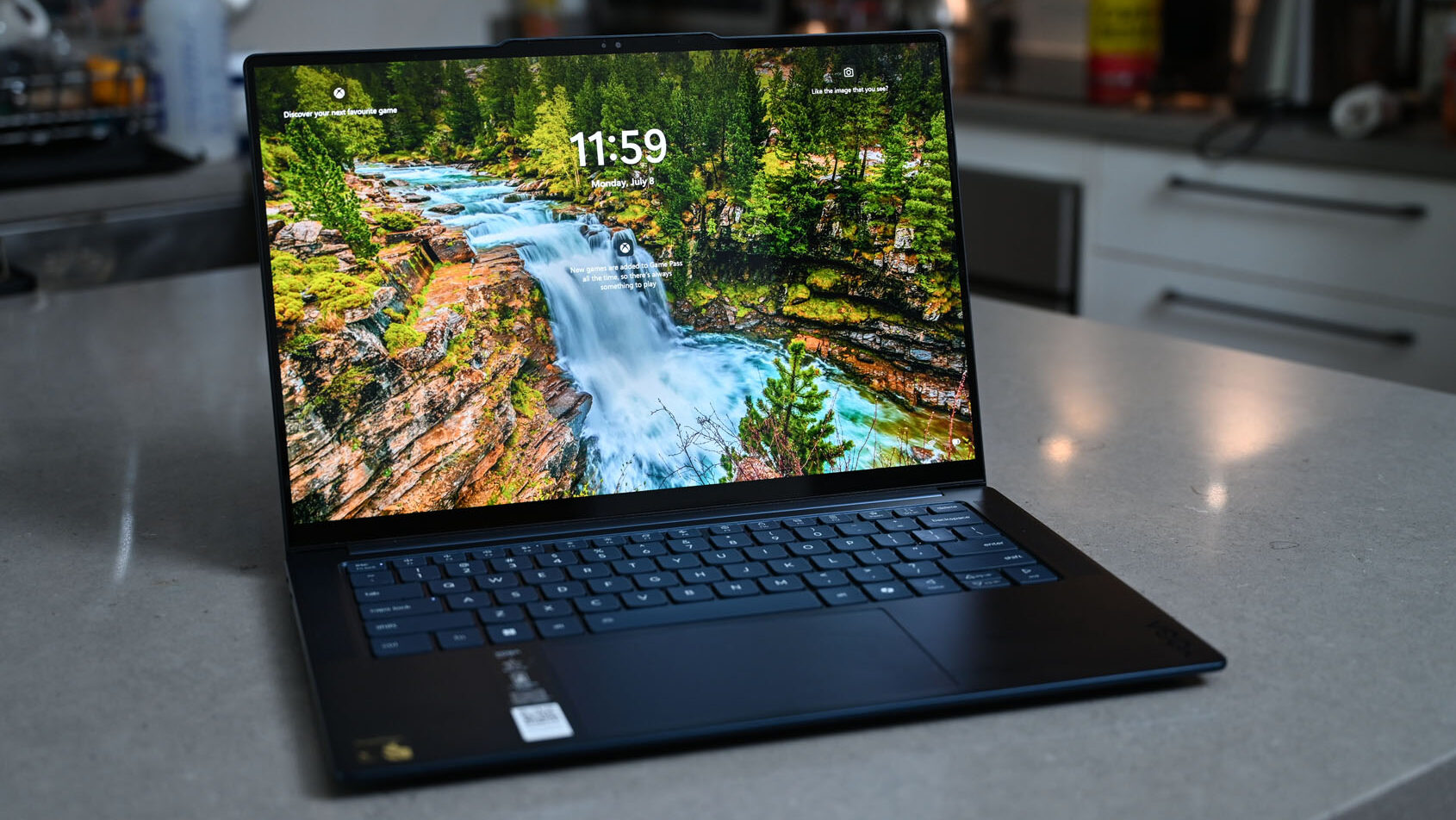 Lenovo Yoga Slim 7x on a kitchen counter.