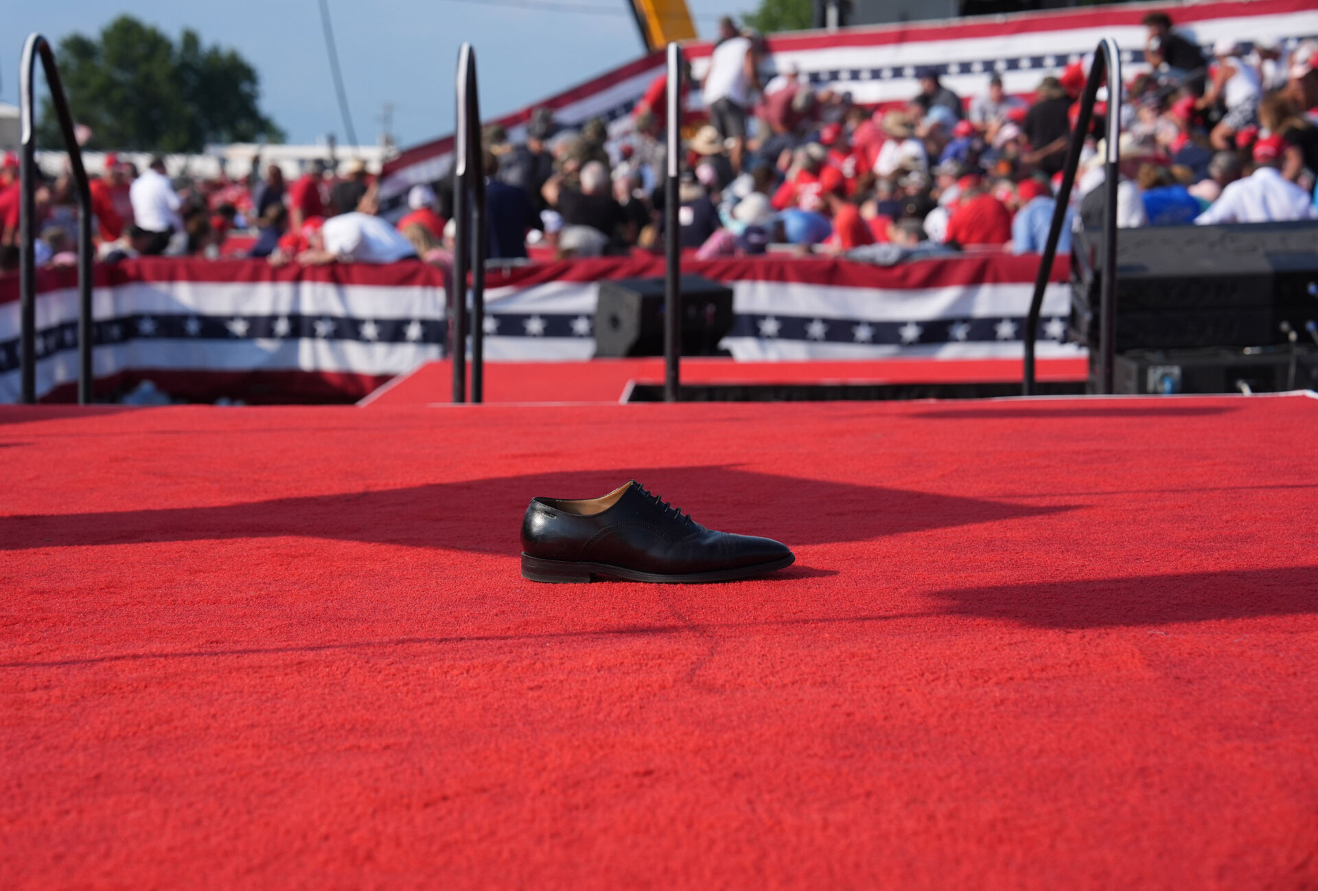 A shoe is left on stage after a former president Donald Trump is assisted offstage during a campaign rally at Butler Farm Show Inc. on Saturday, July 13, 2024 in Butler, Pa.