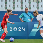 Canada's defender #02 Sydney Collins (L) and New Zealand's defender #04 Cj Bott fight for the ball in the women's group A football match between Canada and New Zealand during the Paris 2024 Olympic Games.