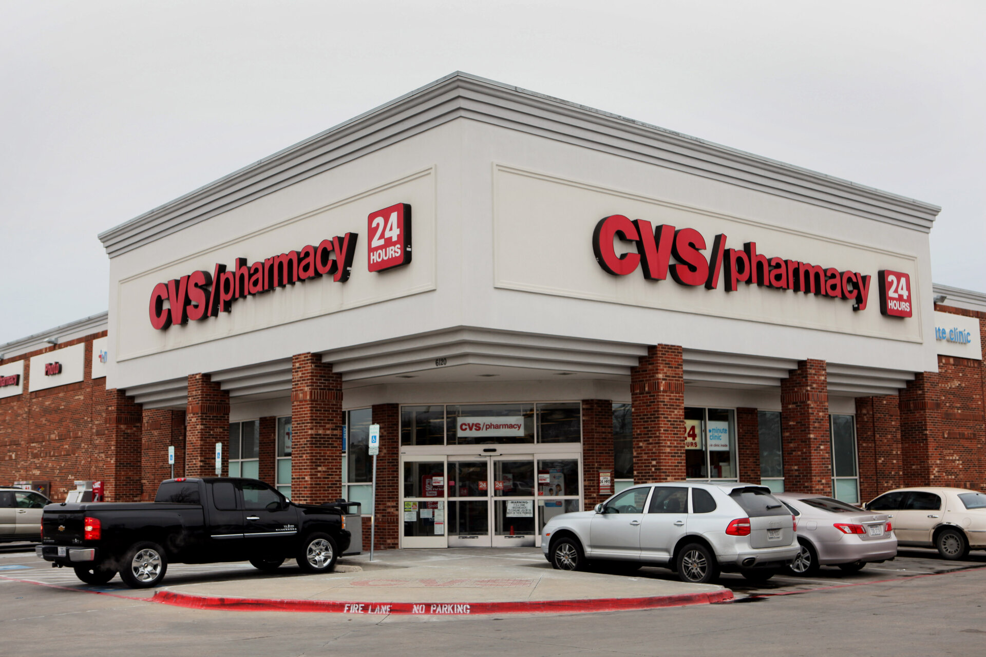 Cars sit parked outside of a CVS Caremark Corp. store in Dallas, Texas, U.S., on Friday, Feb. 7, 2014.