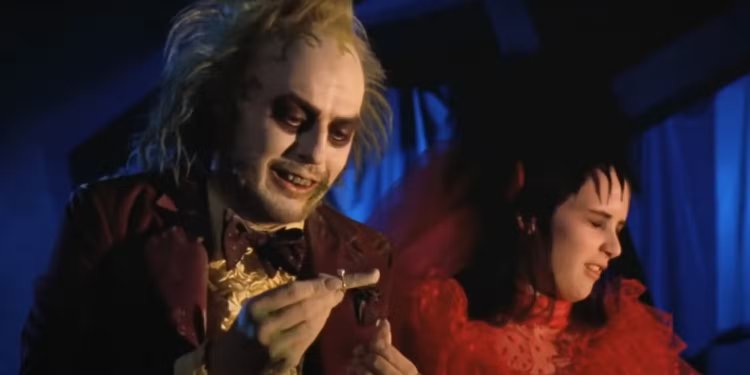 Beetlejuice Holds A Ring And Severed Finger While Lydia Looks Disgusted In Beetlejuice S Wedding Scene