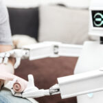 Image of a robot applying a bandage to a person's arm.