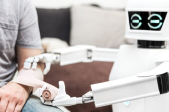 Image of a robot applying a bandage to a person's arm.