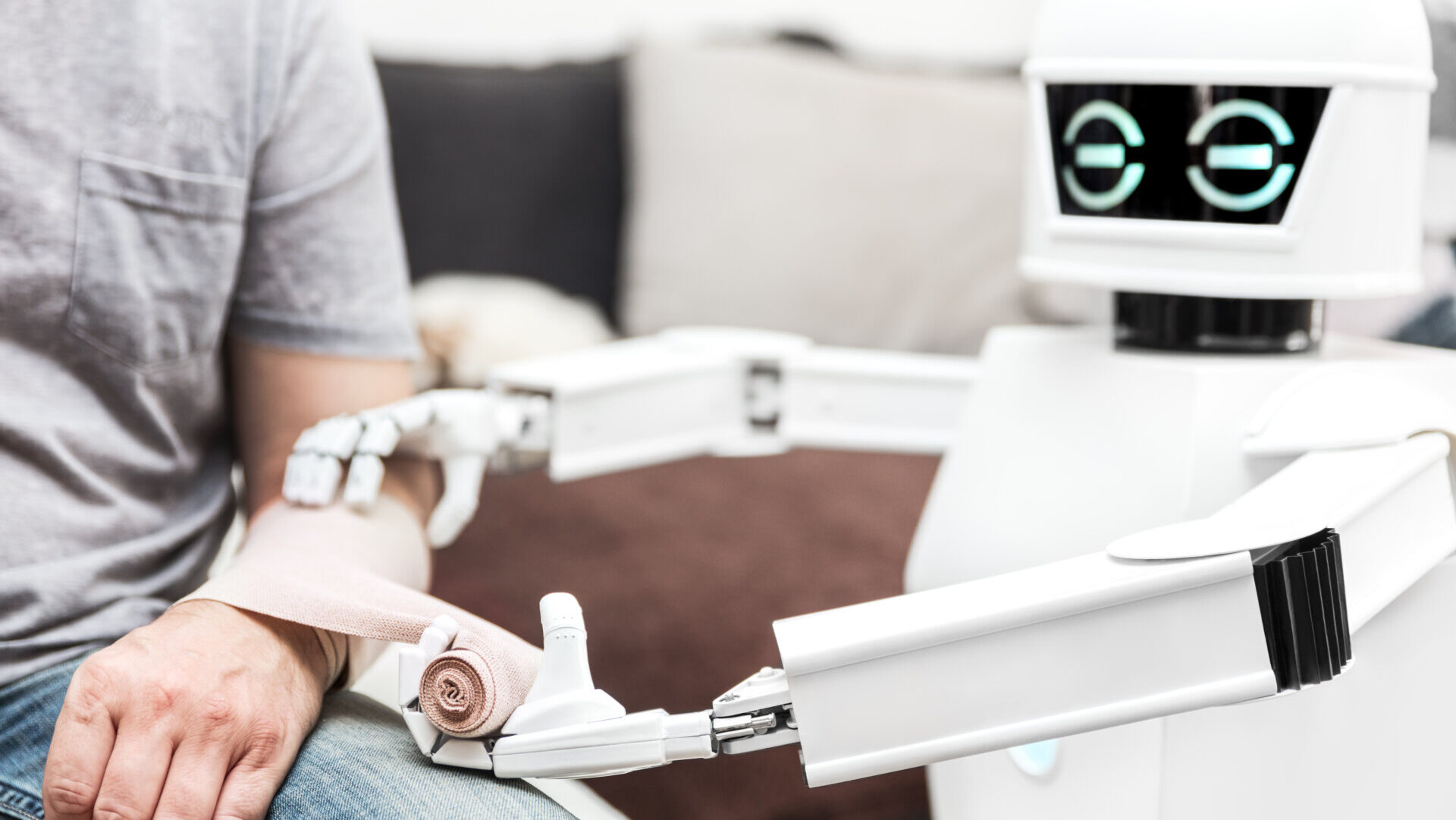 Image of a robot applying a bandage to a person's arm.