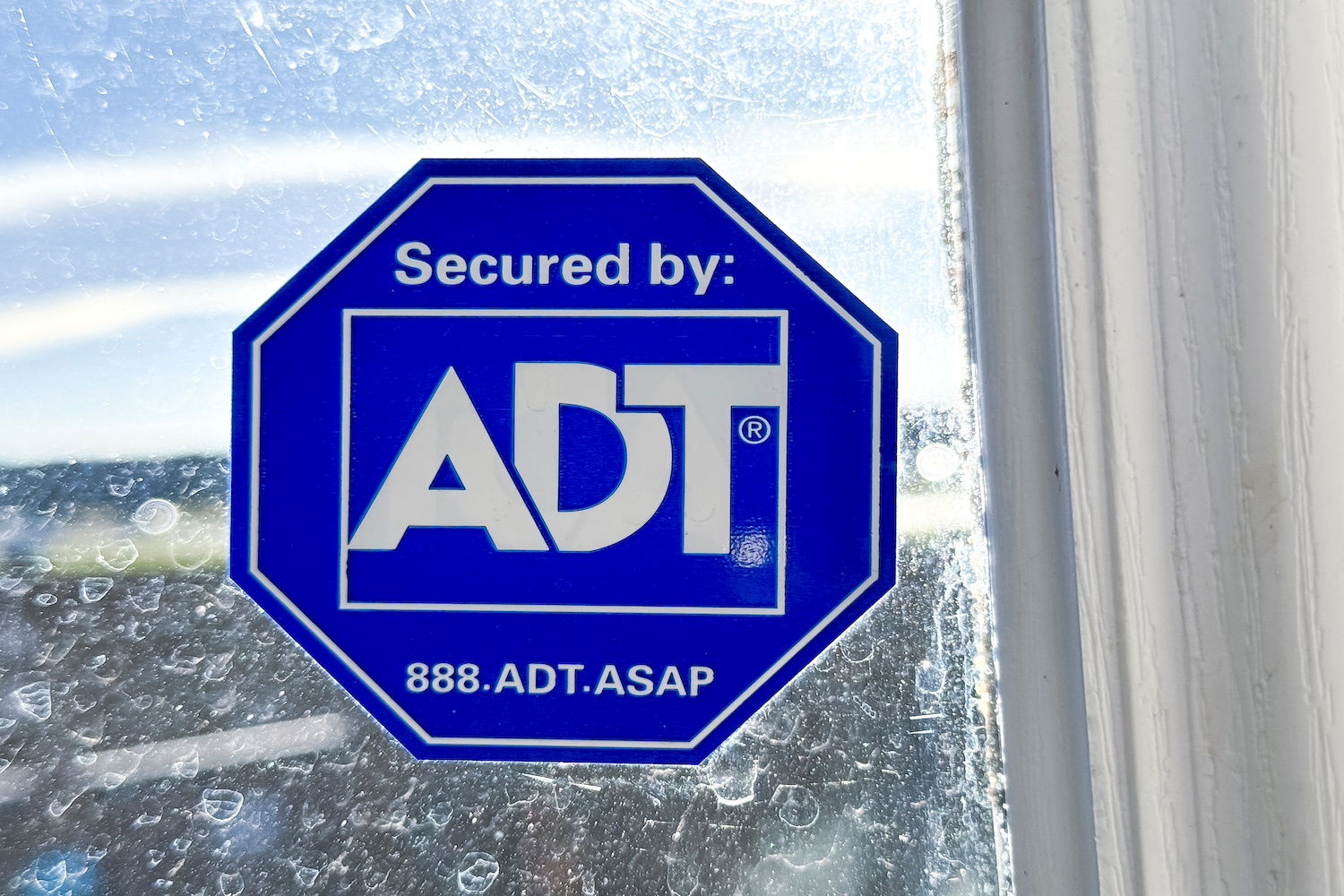 ADT's trademark sticker seen on a window