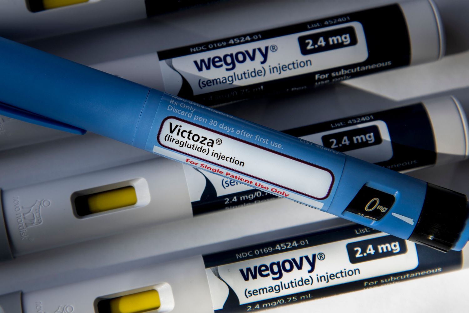 A injection pen of Victoza (liraglutide) on top of pens of Wegovy (semaglutide)