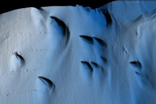 Weird teardrop-shapd structures on the underside of the ice shelf.