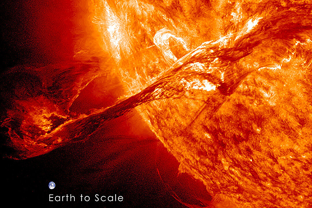 An artist's concept of a massive solar burst, with Earth for scale.