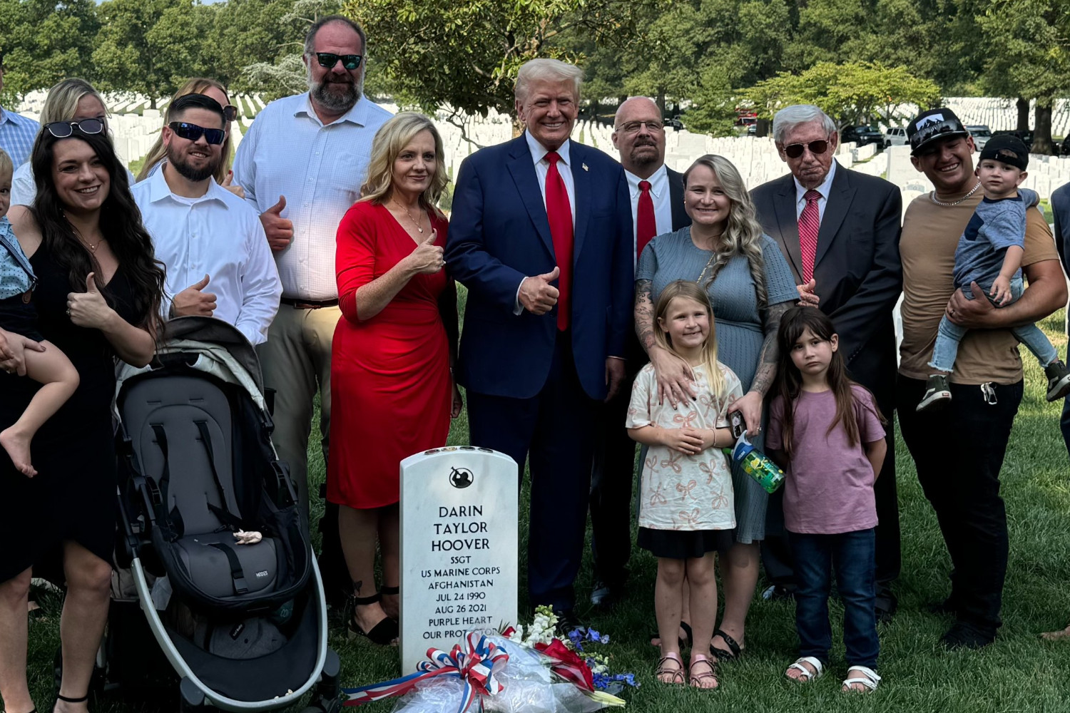 Donald Trump (center) giving a thumbs up at Arlington National Cemetery on August 26, 2024.