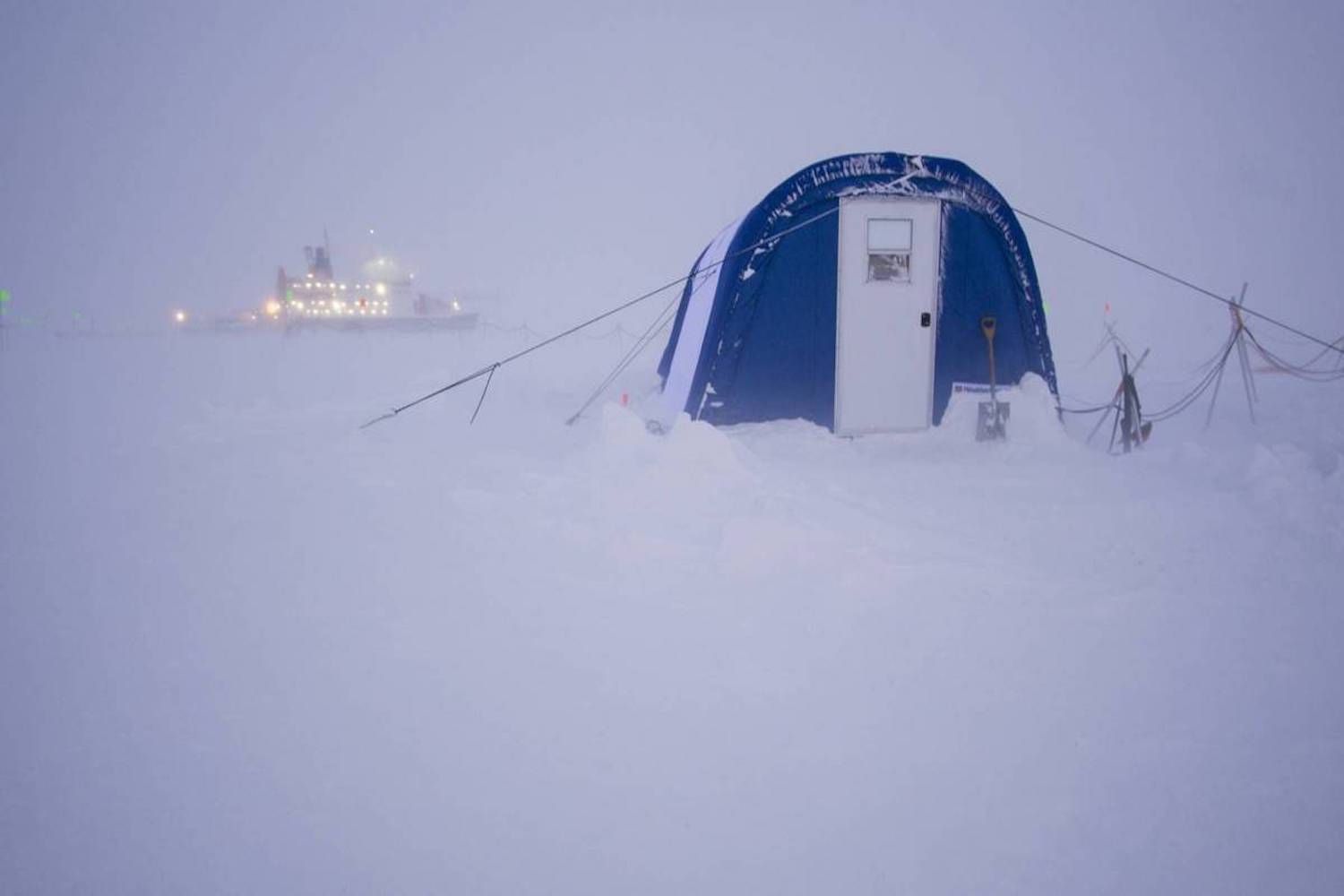 Photo of research vessel and scientist's tent on Arctic ice.