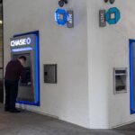 A worker cleans a Chase automated teller machine (ATM) in San Francisco, California, U.S., on Monday, July 12, 2021.