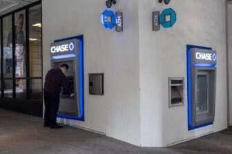 A worker cleans a Chase automated teller machine (ATM) in San Francisco, California, U.S., on Monday, July 12, 2021.