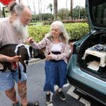 Evacuating from the likely path of Hurricane Milton, Rex and Ruby Thacher bring their dogs Lulu and Zoey to the Rosen Centre Hotel in Orlando on Monday, Oct. 7, 2024.