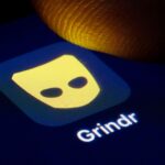 The Grindr app logo on a phone