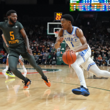 Duke Blue Devils guard Caleb Foster (1) drives to the basket as Miami Hurricanes guard Wooga Poplar (5) defends during the game between the Duke Blue Devils and the Miami Hurricanes on Wednesday, Feb. 21, 2024, at Watsco Center in Coral Gables, Florida. 