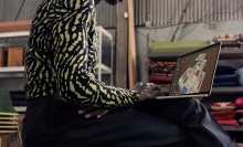 person sitting in loft space working on macbook air on their lap