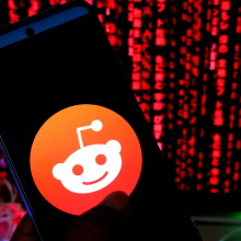 The Reddit logo on a phone