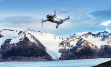 Potensic drone flying above snowy mountain tops 