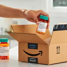 A photograph of an Amazon box with medicines.