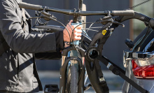 Man hooking up his bike on a bike rack