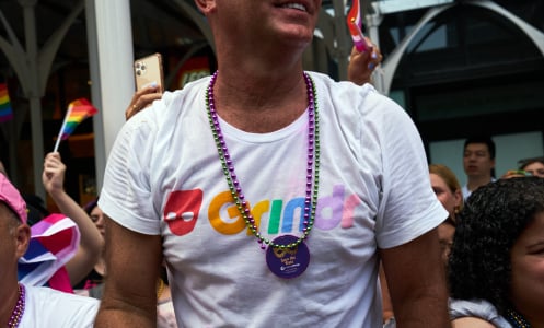 A bystander wears a Grindr t-shirt during the NYC Pride March