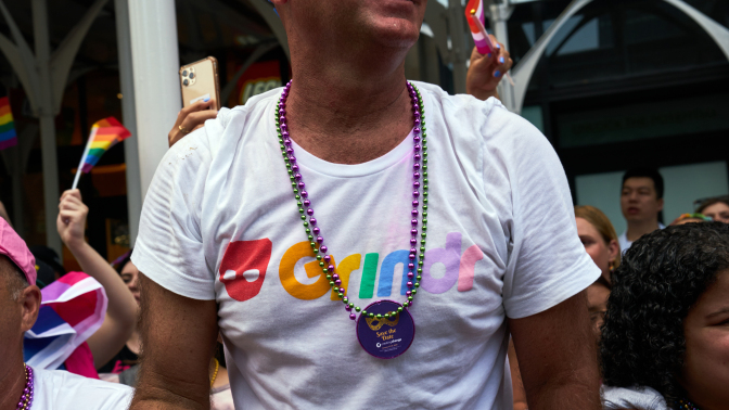 A bystander wears a Grindr t-shirt during the NYC Pride March