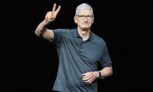 Tim Cook, Apple CEO, flashes a peace sign