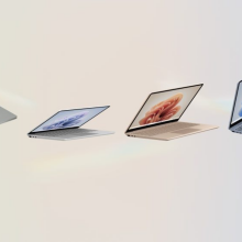 four microsoft surface laptop go 3s against a rainbow pastel background