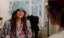 Ashley Park wears a fluffy blue hat in "Emily In Paris."