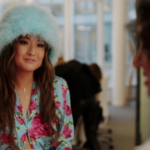 Ashley Park wears a fluffy blue hat in "Emily In Paris."