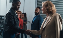 The Doctor shakes hands worriedly with a familiar woman in a business suit. 