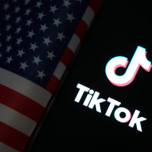 The TikTok logo next to an American flag.