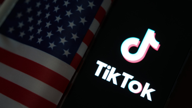 The TikTok logo next to an American flag.