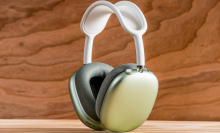 A pair of AirPods Max headphones in green