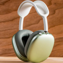 A pair of AirPods Max headphones in green