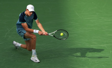 Jannik Sinner of Italy plays a backhand