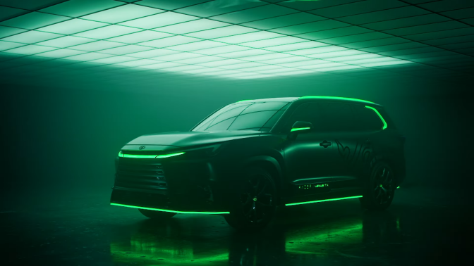 The Razer/Lexus car collaboration vehicle, with a light shining above it and neon lights glowing on the car.