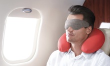Person wearing the Bamboo Sleep Eye Mask on an airplane.