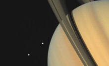 In November 1980, Voyager 1 snapped this image of Saturn and two of the gas giant's moons.