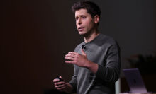 OpenAI CEO Sam Altman speaking onstage at the company's developer conference 