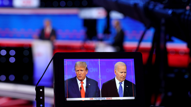 A monitor shows a camera view of the two presidential candidates during the July debate.