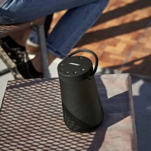 bose soundlink revolve+ speaker on an outdoor table