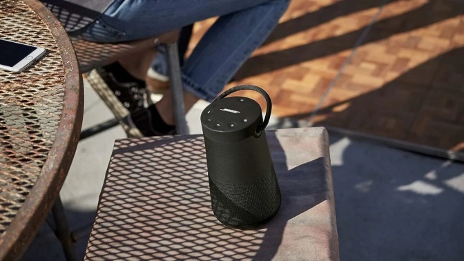 bose soundlink revolve+ speaker on an outdoor table