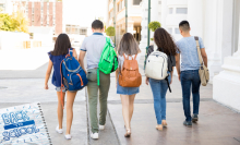 Three students walking at school together.